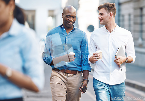 Image of Men, walk and street with takeaway coffee while talk, smile and relax at lunch break. Black man, colleague and diversity in city at tea time, walking to office or workplace in discussion or talking