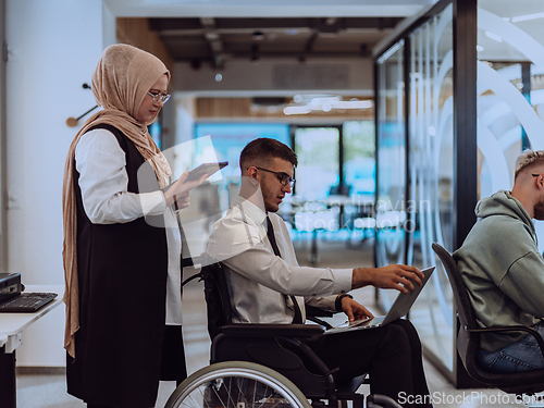 Image of Young group of business people brainstorming together in a startup space, discussing business projects, investments, and solving challenges.