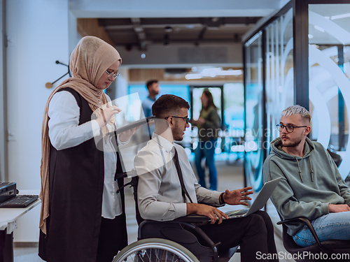 Image of Young group of business people brainstorming together in a startup space, discussing business projects, investments, and solving challenges.