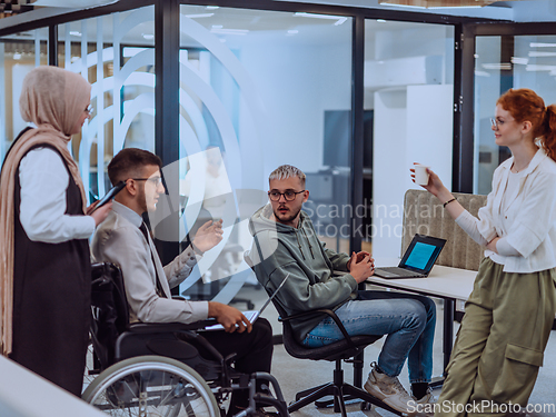 Image of Young group of business people brainstorming together in a startup space, discussing business projects, investments, and solving challenges.