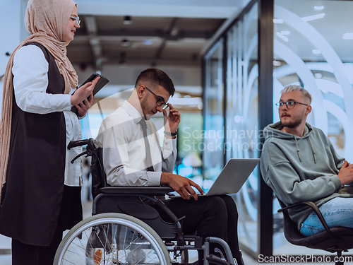 Image of Young group of business people brainstorming together in a startup space, discussing business projects, investments, and solving challenges.