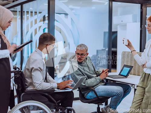 Image of Young group of business people brainstorming together in a startup space, discussing business projects, investments, and solving challenges.