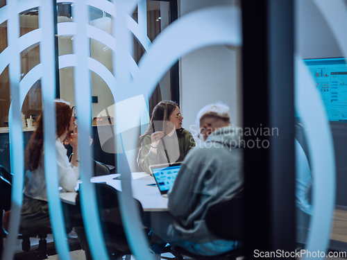 Image of A diverse group of businessmen collaborates and tests a new virtual reality technology, wearing virtual glasses, showcasing innovation and creativity in their futuristic workspace