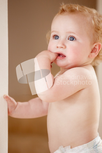 Image of Face, hands and baby in a room for playing, watching or fun, learning, walk or balance. Little, child development and curious boy kid in a nursery playful, standing and enjoy youth, freedom or games