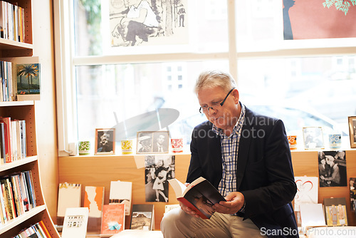 Image of Senior man, library and reading book for literature, knowledge or story at bookstore. Mature male person, author or bookworm sitting by bookshelf for novel, learning or wisdom in shopping or leisure