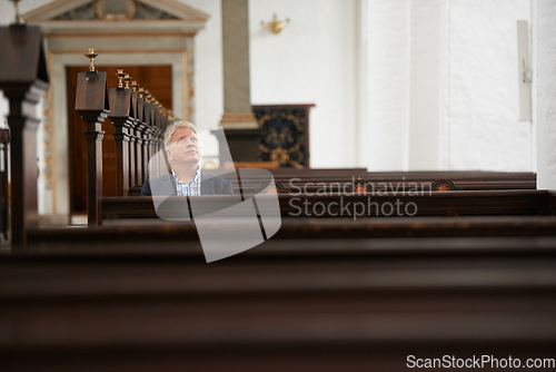 Image of Senior man, sitting and church for religion, faith or pray at cathedral or holy grounds in Jesus Christ. Mature or religious male person looking up in sanctuary for salvation, forgiveness or worship