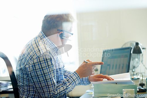 Image of Man, virtual assistant and headset for telecom in office for consultation, advice or customer care. Senior person, call centre and agent with discussion, talk or communication for help with help desk
