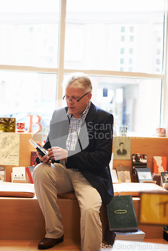 Image of Senior man, library and author with book for literature, knowledge or story at bookstore. Mature male person, reader or bookworm reading novel, learning or wisdom in shopping choice, decision or pick