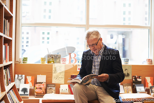 Image of Senior man, library and author reading book for literature, knowledge or story at bookstore. Mature male person or information by bookshelf for novel, learning or wisdom in shopping or leisure