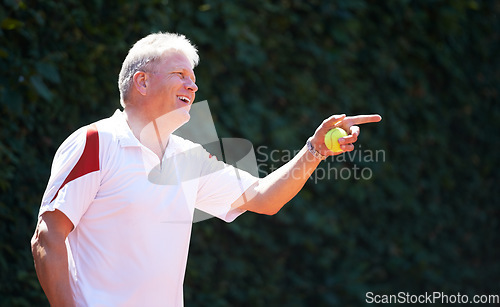 Image of Happy, senior man and game of tennis on court for exercise, workout and training in sport. Hand, pointing and mature person smile with energy, fitness and playing in healthy competition in retirement