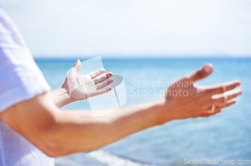 Image of Hands, worship and man at the sea with happiness and praise God for blessing, water and spiritual peace. Person, closeup or respect Jesus Christ with gratitude, freedom and hope at the ocean or beach