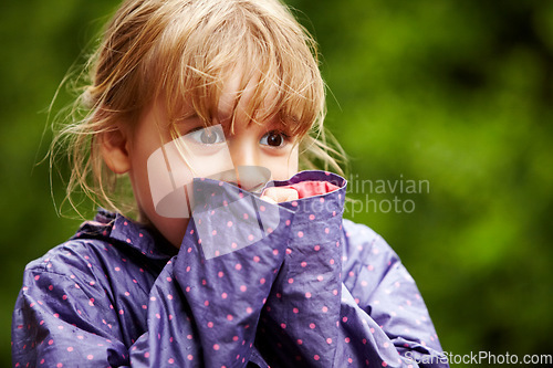 Image of Child, play and outdoor nature in raincoat for winter youth fun, explore or travel in cold weather. Young girl, happy or excited or relax holiday on vacation break as wet game or joy, surprise as kid