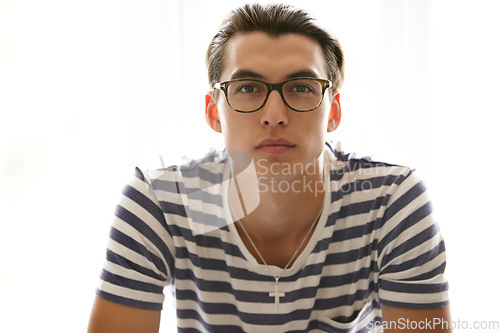 Image of Serious, man and portrait with glasses in studio, white background and eyewear spectacles mockup. Person, face and Christian male with necklace and frames with lenses for vision, sight and fashion