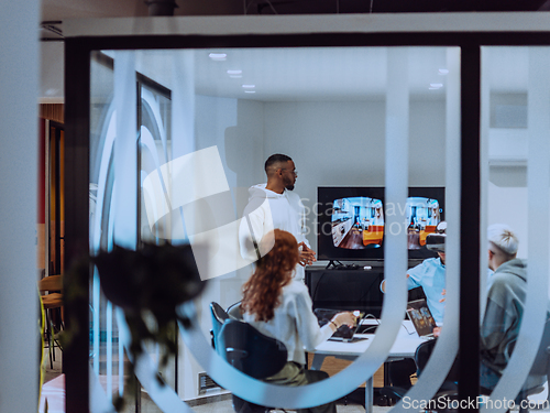 Image of A diverse group of businessmen collaborates and tests a new virtual reality technology, wearing virtual glasses, showcasing innovation and creativity in their futuristic workspace