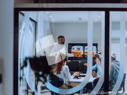 Image of A diverse group of businessmen collaborates and tests a new virtual reality technology, wearing virtual glasses, showcasing innovation and creativity in their futuristic workspace