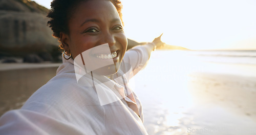 Image of Woman, selfie and beach or portrait at sunrise, relaxing and peace for social media, post and update on holiday. Happy black person, pointing and ocean on vacation, getaway and travel, fun or nature