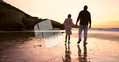 Image of Father, son and holding hands at beach, sunset and support or trust, ocean and solidarity or care. Black family, sea and love or fatherhood, bonding and water on vacation, holiday and peace at dusk