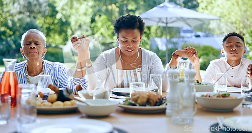 Image of Holding hands, black family or kid praying for food to worship God together for faith or gratitude. Grandmother, backyard or African mom with child in nature for a meal, brunch or lunch with grace