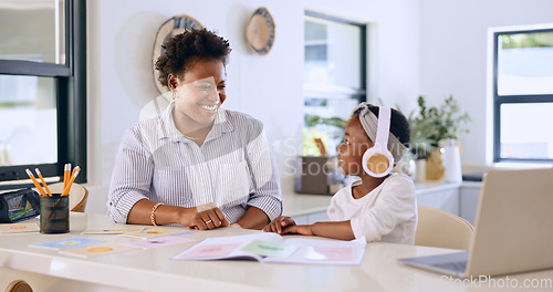 Image of Child, woman or happy with headphones for learning, kitchen or home school for online education on project. Mother, daughter or smile by counter in distance study, technology or audio lesson in house