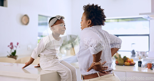 Image of Tired, mom and child in kitchen together, talking and bonding with back pain, breakfast and burnout. Fatigue, mother and daughter on home counter with stress, exhausted and getting ready in morning.