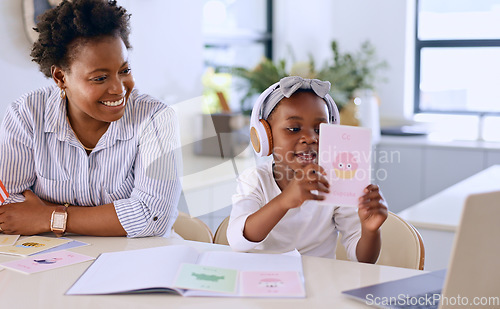 Image of Learning, laptop and mom with child in home on letters with kindergarten, project and elearning homework. Color, card and mother with girl listening to video on computer for education or development