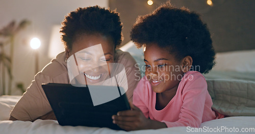 Image of Mom, child and tablet in bedroom, watching cartoons and night time in bed, technology and laugh. Happy, enjoying and online for videos, digital and internet in home, streaming or bonding together