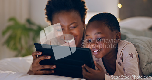 Image of Mother, child and tablet in bedroom at night watching cartoons in bed with technology and laugh. Happy, enjoying and online for videos, digital and internet in home streaming or bonding together