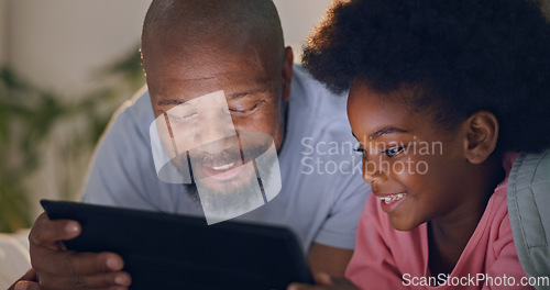 Image of Father, child and tablet in bedroom at night watching cartoons and in bed with technology and laugh. Happy, enjoying and online for videos, digital and internet in home streaming or bonding together