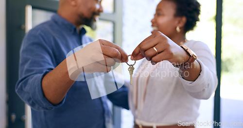 Image of Hands, moving and holding of key in new home with closeup for real estate, property investment or mortgage. Couple, man or woman for new beginning in marriage with love, care or bond in relationship