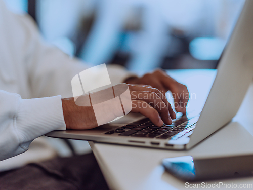 Image of Close up photo of African American businessman is diligently working on his laptop, embodying determination, ambition, and productivity in his professional environmen