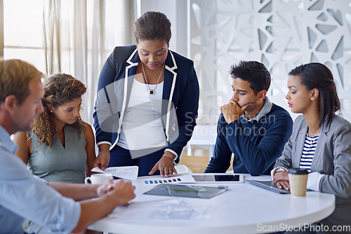 Image of Business people, meeting and discussion in office with brainstorming, collaboration and documents or serious. Employees, men and women at corporate workplace with communication and planning with tech