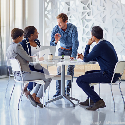 Image of Business people, meeting or discussion with brainstorming for planning, collaboration and technology at table. Employees, men or women at corporate workplace with communication and speaker or smile.