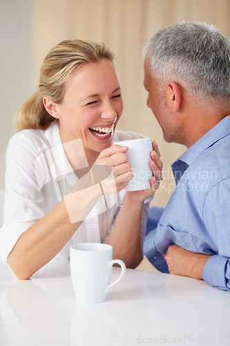 Image of Mature, coffee or happy couple laughing in home living room bonding or speaking of joke together. Love, discussion or funny man at a table in conversation, talking or drinking espresso tea with woman