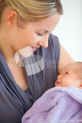 Image of Closeup, woman and holding of baby in home for love, care or bonding in relationship. Female person, motherhood and looking at child for hope, future or new life for development, milestone or growth