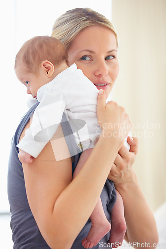 Image of Mother, holding and bonding hug with baby for love, care support and gratitude for wellness with commitment. Woman, smile and cute newborn with blonde hair, blue eyes and kindness with trust safety