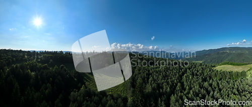 Image of Aerial view of mountain peaks and fresh green grass on a sunny summer day