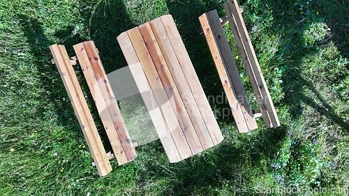 Image of Rustic wooden picnic table in the backyard top view