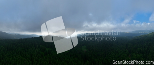 Image of Aerial hyperlapse timelapse aerial view of clouds and mountains with green forest