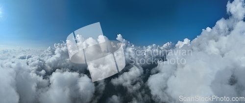 Image of Drone flight above clouds during a misty sunrise morning