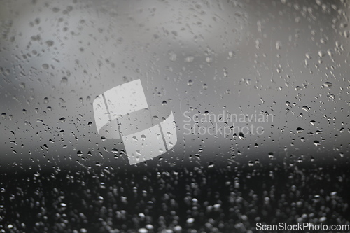 Image of Water drops on fogged glass with a gray brightness gradient