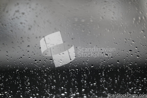 Image of Water drops on fogged glass with a gray brightness gradient