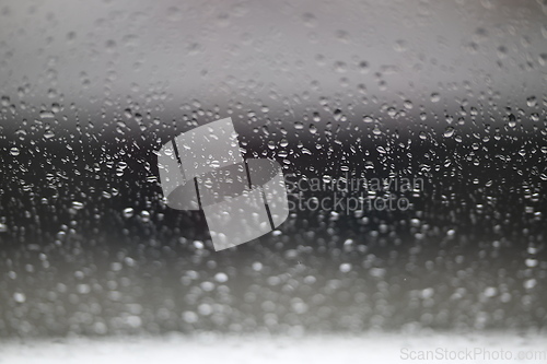 Image of Water drops on fogged glass with a gray brightness gradient