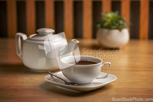 Image of Herbal tea with white tea cup and teapot