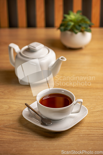 Image of White tea kettle and white cup