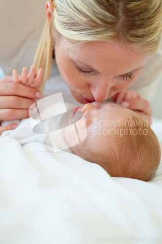 Image of Closeup, mom and baby with kiss on bed for love, care and bonding in relationship. Infant, sleep or dreaming of hope, future or new life with growth, milestone or child development in family home