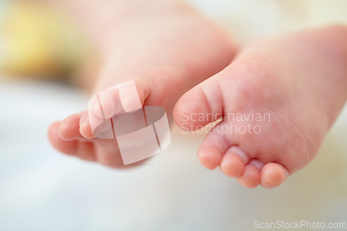 Image of Closeup, baby and feet for hope in home for future, childhood or development. Infant, toes or growth for milestone with family, care and protection for safety in nursery for wellness, peace or health