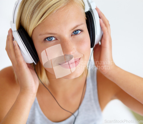 Image of Portrait, smile and woman with headphones, streaming music and listening to audio with radio, apartment and sound. Face, home and person with a headset, podcast and wellness with peace and hearing