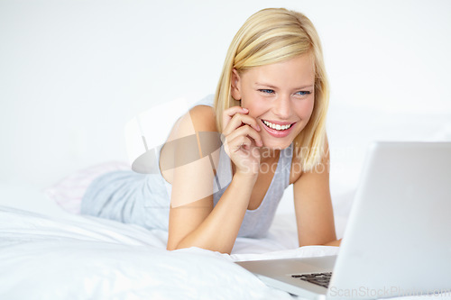 Image of Happy, laptop and woman on bed for watching movies, online shopping and internet in bedroom. Relax, smile and person on computer for streaming subscription, videos and series on weekend at home