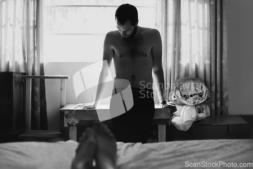 Image of Man, bedroom and depressed with thinking and cheating with black and white and beard at home. Art, fashion and male person in a house with a problem and anxiety with lonely grief and monochrome