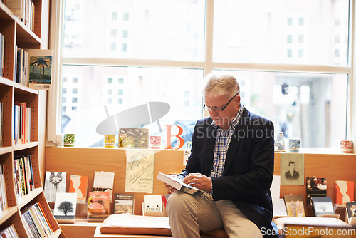 Image of Senior man, library and reading book for literature, knowledge or story at bookstore. Mature male person, author or bookworm sitting by bookshelf for novel, learning or wisdom in shopping or leisure